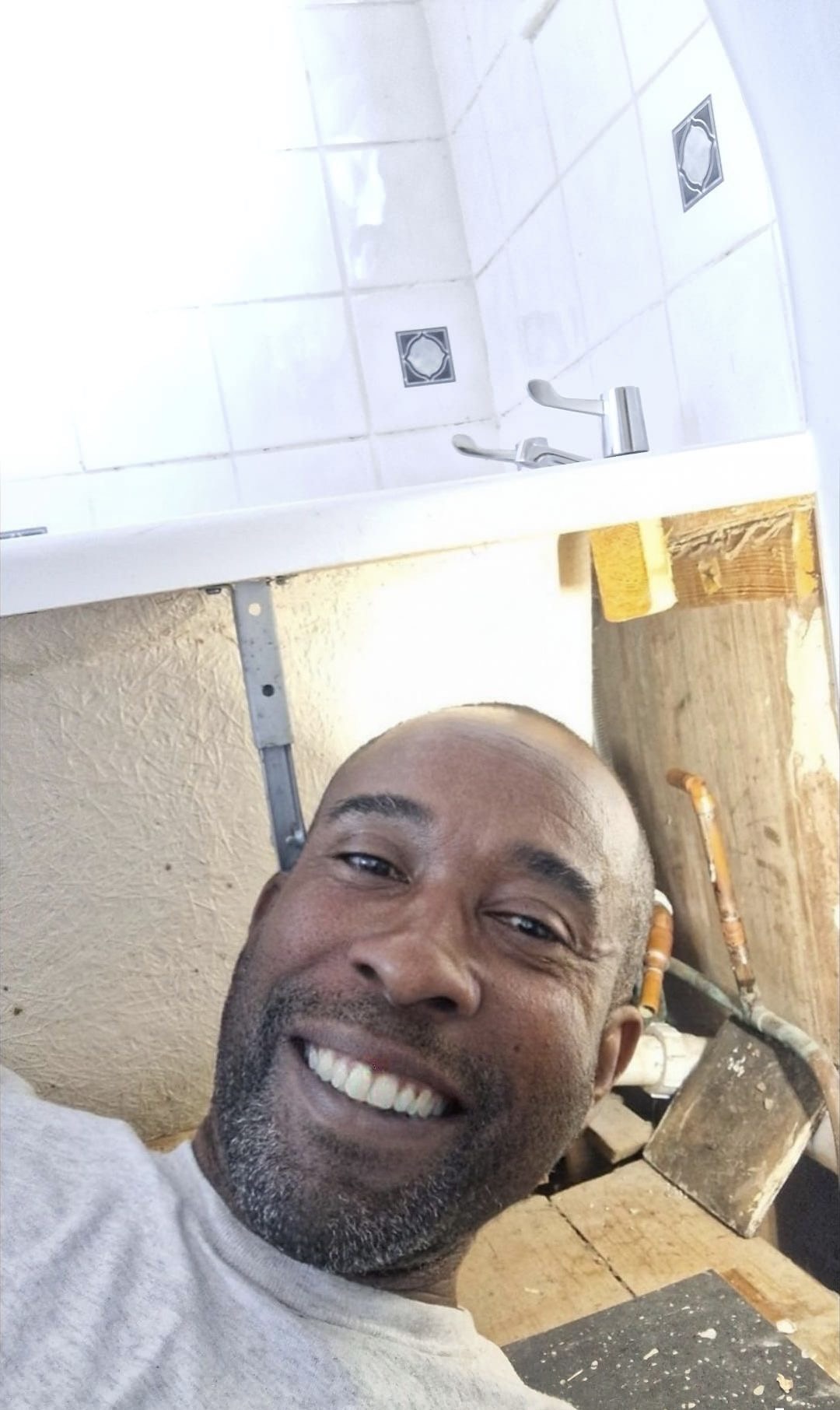 Matt on the job, fitting a basin in a Birmingham home